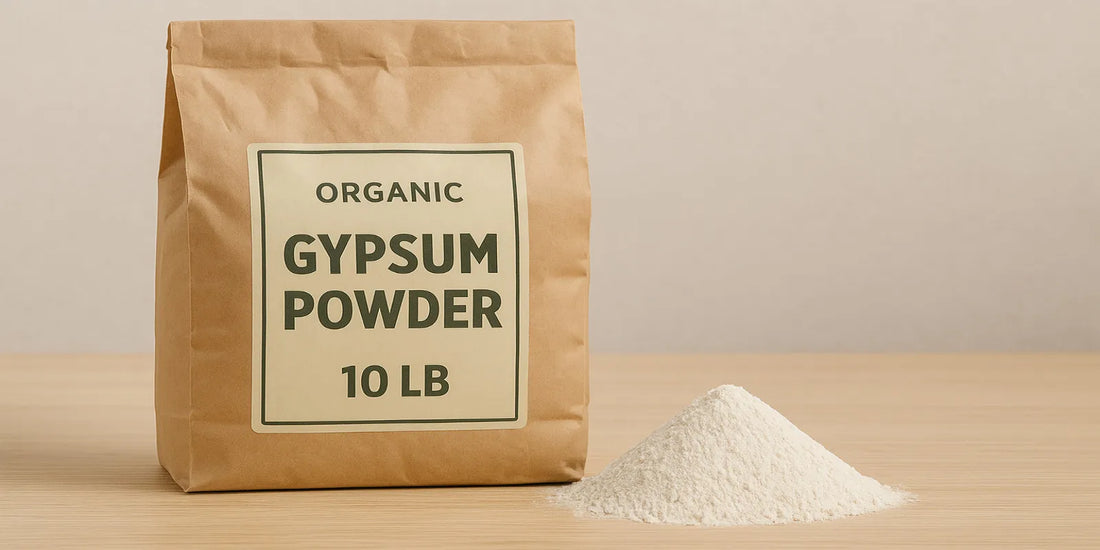 A 10lb kraft paper bag labeled organic gypsum powder stands beside a small mound of fine white powder on a wooden surface.