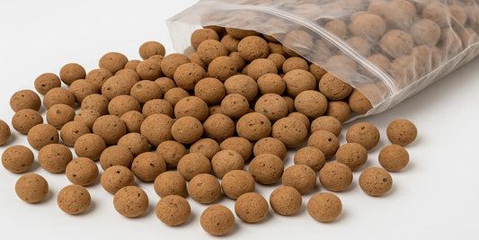 Close-up view of Legigo 8LBS expanded clay pebbles (LECA balls) spilling from a plastic bag, ideal for plant drainage and hydroponics.